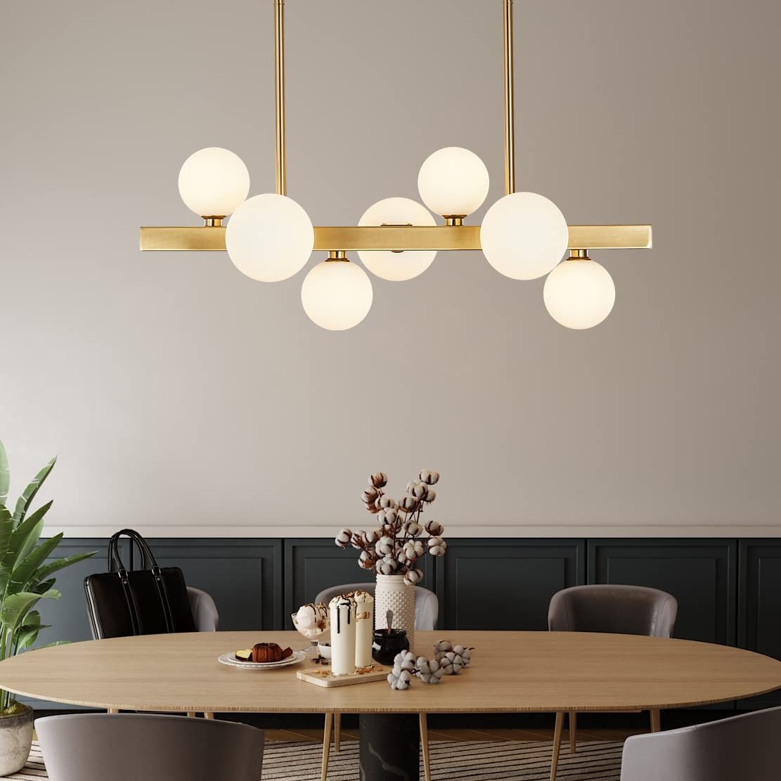 Modern chandelier with globe lights above a dining table