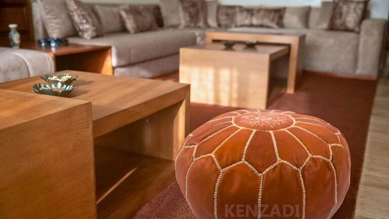 Brown leather ottoman in a living room with a sectional sofa
