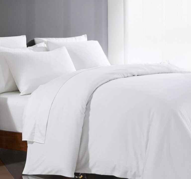 White bedding set with pillows on a bed in a bright room