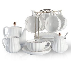 White tea set with gold trim, including cups, saucers, and a teapot