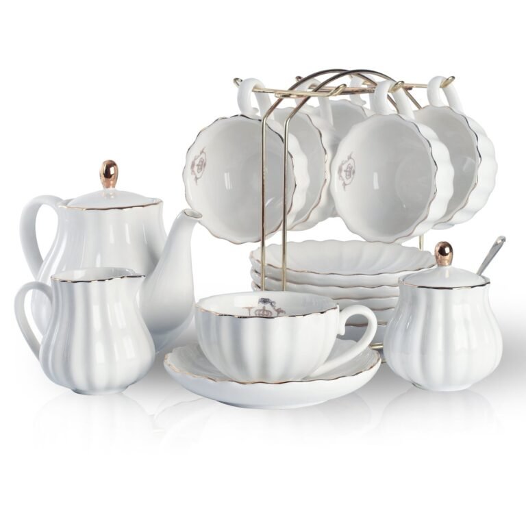 White tea set with gold trim, including cups, saucers, and a teapot