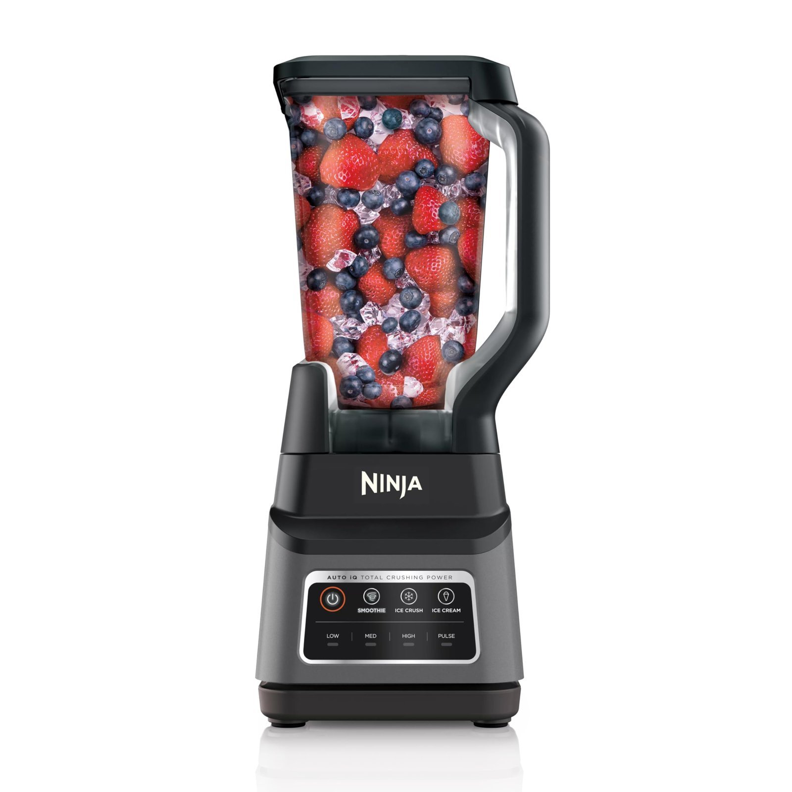 Ninja blender filled with strawberries, blueberries, and ice cubes