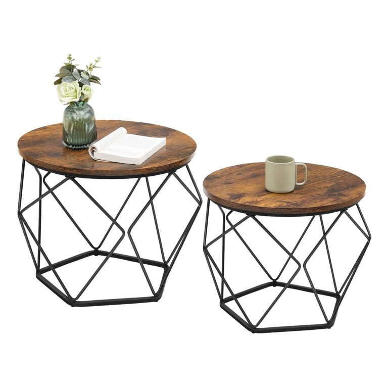 Two round coffee tables with geometric black metal bases and decor