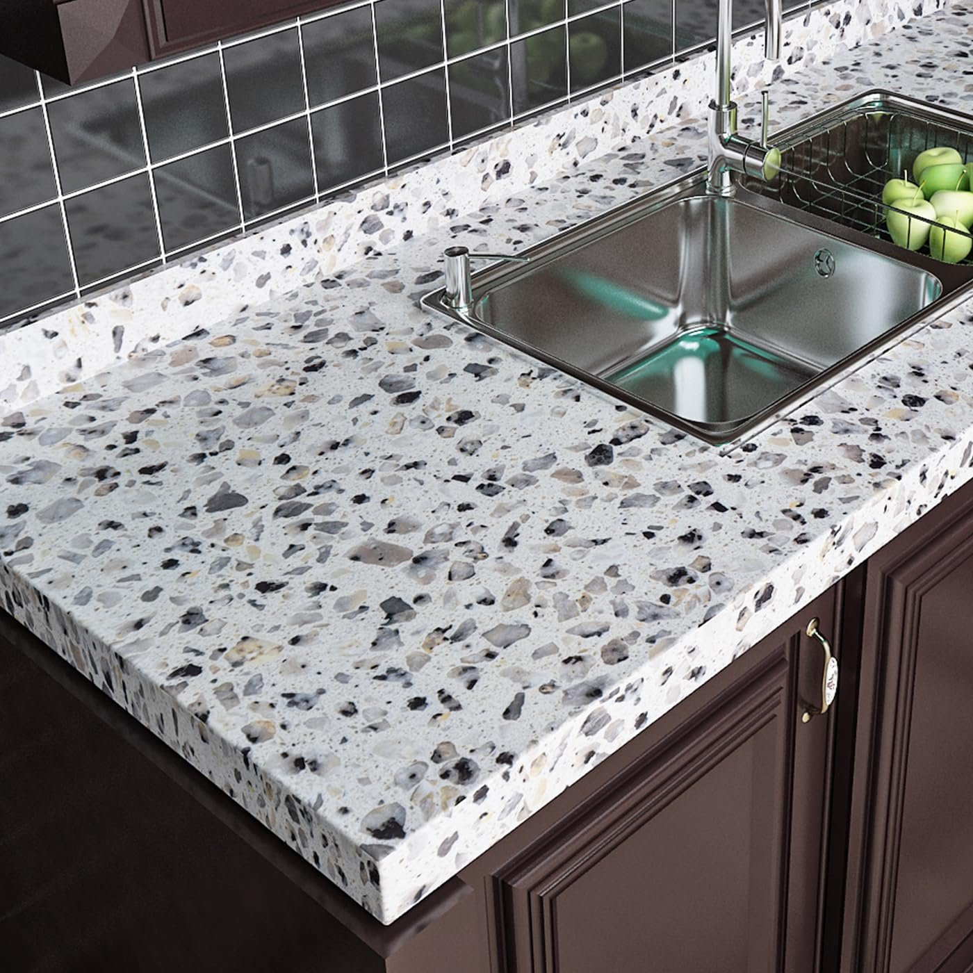 Kitchen countertop with stainless steel sink and green apples