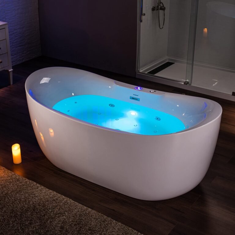 Modern white bathtub with blue illuminated water, candles, and shower