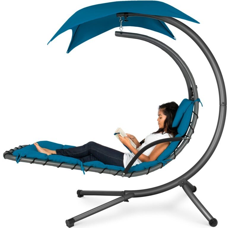 Woman reading in a hanging chair with blue canopy and cushions