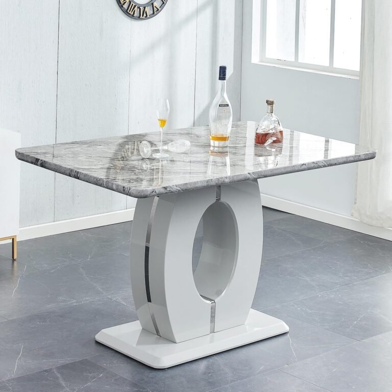 Modern dining table with marble top, white base, and liquor bottles