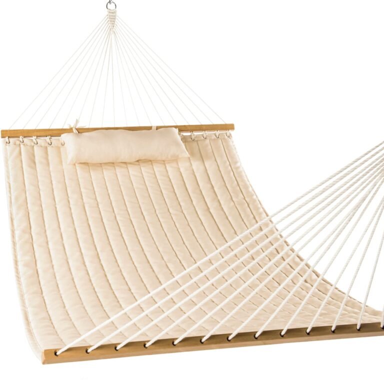 Cream-colored quilted hammock with pillow, wooden bars, and white rope supports
