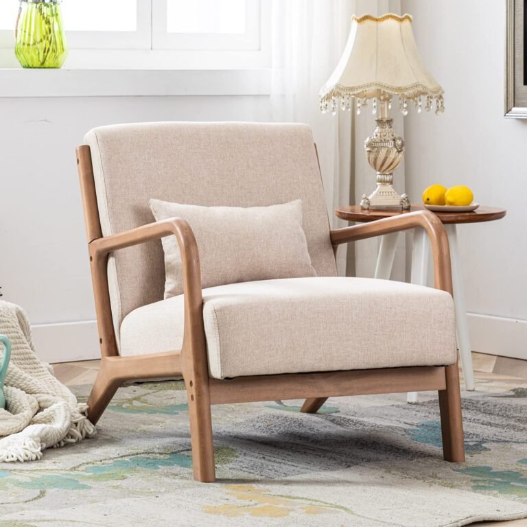 Beige armchair with wooden frame, pillow, side table, and lamp