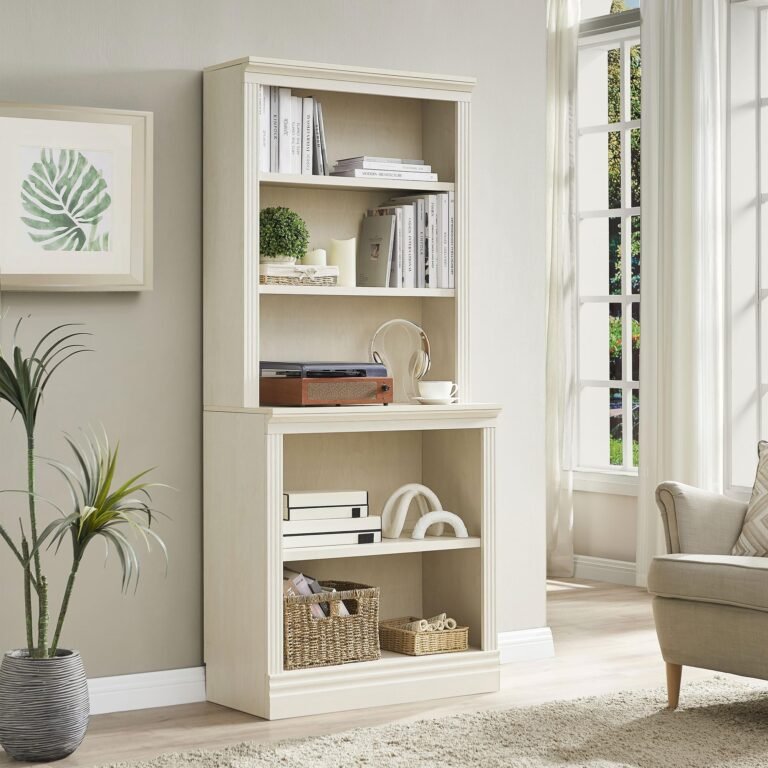 White bookshelf with books, decor, and a record player in a bright room