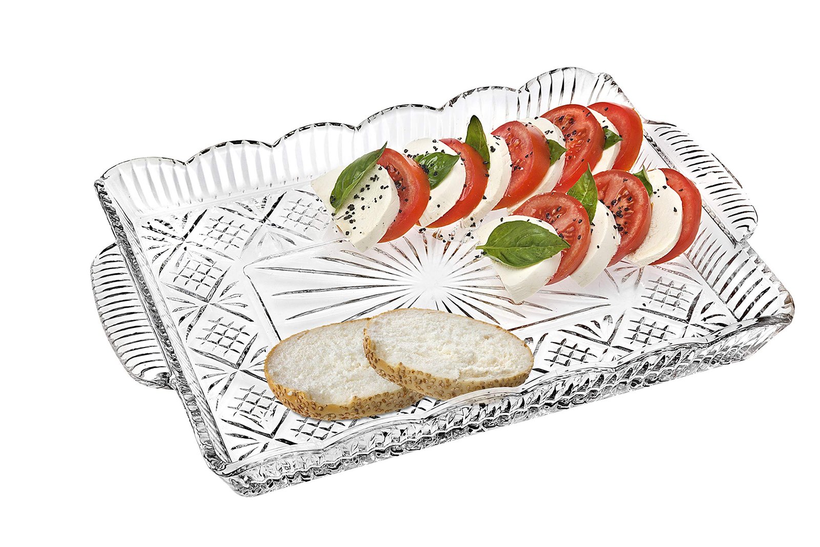 Caprese salad with bread on a decorative glass serving tray