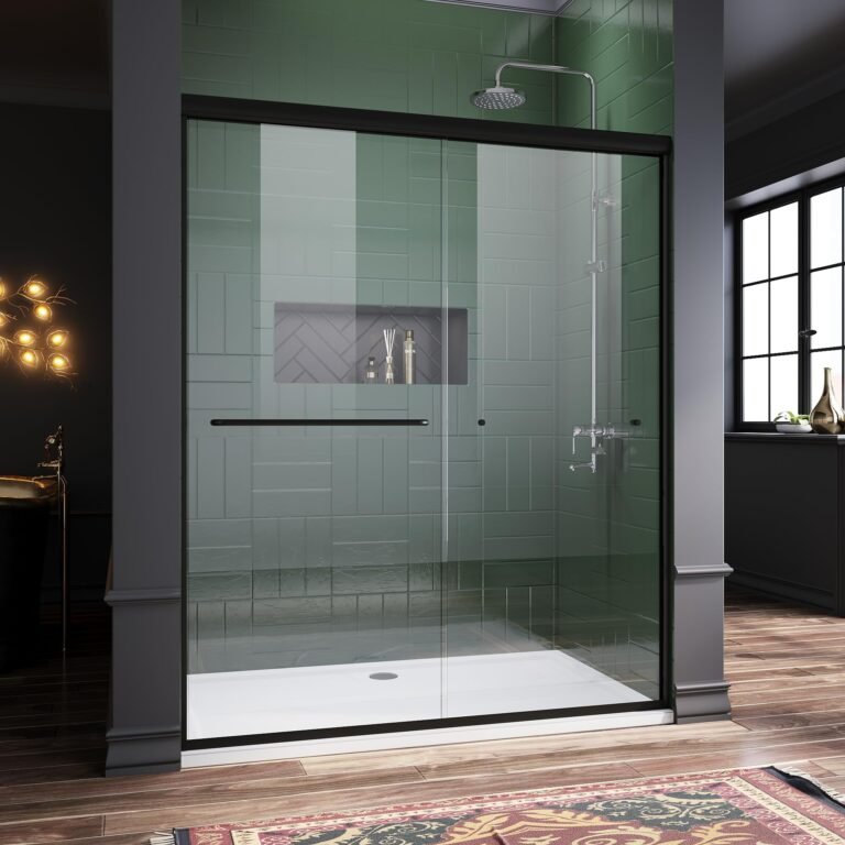 Modern shower with glass door, green tile, and built-in shelf