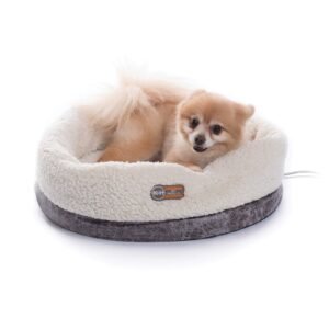 Small dog resting in a heated pet bed