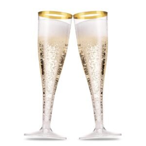 Two champagne flutes filled with bubbly champagne, gold rim