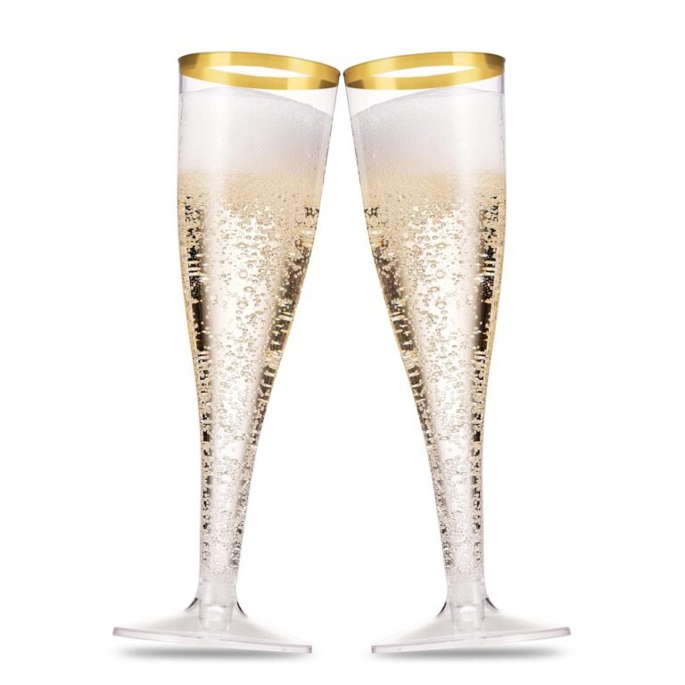 Two champagne flutes filled with bubbly champagne, gold rim