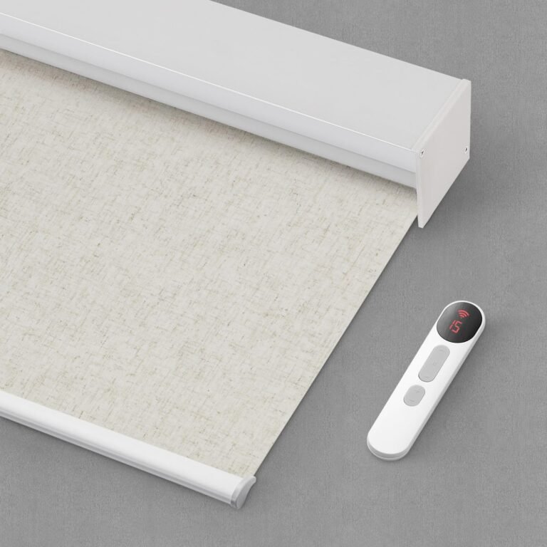 White roller blind with remote control on a gray surface